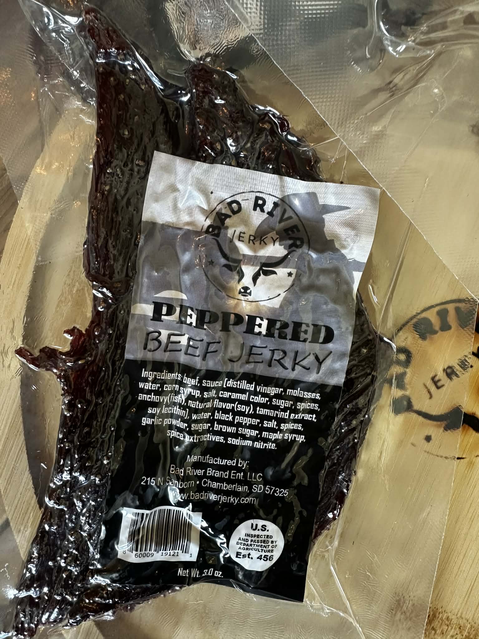 Peppered beef jerky pieces – close-up of hand-torn texture
